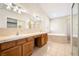 Spacious bathroom with double sinks, a soaking tub, and tile flooring at 6860 Stubblefield Dr, Pahrump, NV 89061