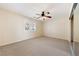 Spacious bedroom with a window and mirrored closet doors at 6860 Stubblefield Dr, Pahrump, NV 89061