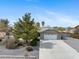 Charming single-story home featuring desert landscaping, a two-car garage, and a welcoming exterior at 6860 Stubblefield Dr, Pahrump, NV 89061