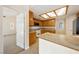 Cozy kitchen featuring wood cabinets, tile backsplash, and a breakfast bar open to living spaces at 6860 Stubblefield Dr, Pahrump, NV 89061