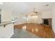 Open-concept living room featuring a stone fireplace and wood floors at 6860 Stubblefield Dr, Pahrump, NV 89061