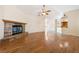 Bright, open living room with hardwood floors and a stone fireplace at 6860 Stubblefield Dr, Pahrump, NV 89061