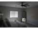 Spacious bedroom boasts a ceiling fan, large mirror, and multiple windows that provide plenty of natural light at 7022 Judith River St, North Las Vegas, NV 89084