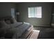 Spacious bedroom boasts a ceiling fan, large mirror, and multiple windows that provide plenty of natural light at 7022 Judith River St, North Las Vegas, NV 89084