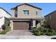 Two-story home featuring a brick driveway, neutral stucco, and an attached two-car garage at 7022 Judith River St, North Las Vegas, NV 89084
