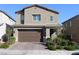 Two-story home featuring a brick driveway, neutral stucco, and an attached two-car garage at 7022 Judith River St, North Las Vegas, NV 89084