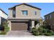 Home exterior exhibiting a brick driveway, manicured bushes, and a modern two-car garage at 7022 Judith River St, North Las Vegas, NV 89084
