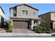 Two-story home featuring a brick driveway, neutral stucco, and an attached two-car garage at 7022 Judith River St, North Las Vegas, NV 89084