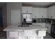 Bright kitchen with white cabinets, center island with marble countertops, and stainless steel appliances at 7022 Judith River St, North Las Vegas, NV 89084