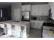 Bright, modern kitchen featuring stainless steel appliances, white cabinets, and an island with bar stool seating at 7022 Judith River St, North Las Vegas, NV 89084