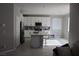 Bright, eat-in kitchen with white cabinets, a center island, and stainless steel appliances at 7022 Judith River St, North Las Vegas, NV 89084