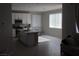 Bright, eat-in kitchen with white cabinets, a center island, and stainless steel appliances at 7022 Judith River St, North Las Vegas, NV 89084