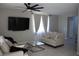 Comfortable living room with a large television, neutral tones, and plenty of seating at 7022 Judith River St, North Las Vegas, NV 89084