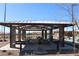 Shaded picnic area with stone pillars, barbecues, and picnic tables for outdoor dining and relaxation at 7022 Judith River St, North Las Vegas, NV 89084
