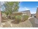 Exterior view of a property's backyard with low maintenance landscaping and covered patio at 7741 Fruit Dove St, North Las Vegas, NV 89084