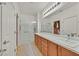 Bathroom with double sinks, a large mirror, and a glass shower at 7741 Fruit Dove St, North Las Vegas, NV 89084
