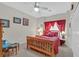 A comfortable bedroom includes warm wooden accents and an inviting color scheme, perfect for relaxation and rest at 7741 Fruit Dove St, North Las Vegas, NV 89084