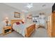 Serene bedroom featuring a wooden bed frame, cozy linens, a ceiling fan, and lots of natural light at 7741 Fruit Dove St, North Las Vegas, NV 89084