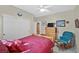The bedroom features sliding closet doors, a ceiling fan, and a chair, creating a comfortable, inviting space at 7741 Fruit Dove St, North Las Vegas, NV 89084