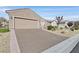 Charming single-story home showcasing a two-car garage, low-maintenance landscaping and neutral paint scheme at 7741 Fruit Dove St, North Las Vegas, NV 89084