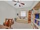 Study room with a ceiling fan, sofa, and built-in bookshelves at 7741 Fruit Dove St, North Las Vegas, NV 89084