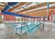 Bright indoor pool area with skylights and ample space for swimming and relaxation at 7741 Fruit Dove St, North Las Vegas, NV 89084