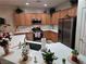 Bright kitchen showcasing wooden cabinetry, stainless steel appliances, and an undermount sink at 7741 Fruit Dove St, North Las Vegas, NV 89084