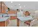 Modern kitchen featuring stone countertops, white appliances, and ample cabinet space at 7741 Fruit Dove St, North Las Vegas, NV 89084