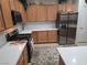This kitchen boasts stainless steel appliances, granite countertops, and wood cabinets, offering style and function at 7741 Fruit Dove St, North Las Vegas, NV 89084