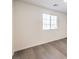 Bedroom with wood-look floors and a window at 7910 Pandora Sky St # 271, North Las Vegas, NV 89084