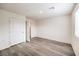 A bright, empty bedroom with wood floors and a window offering natural light at 7910 Pandora Sky St # 271, North Las Vegas, NV 89084