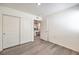 Bedroom with wood-look floors, closet, and an open doorway leading to another room at 7910 Pandora Sky St # 271, North Las Vegas, NV 89084