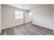 Simple bedroom with wood floors, a window, and white walls providing a blank canvas at 7910 Pandora Sky St # 271, North Las Vegas, NV 89084