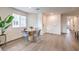 A cozy dining area with natural light and wood flooring offers a view into the hallway and kitchen at 7910 Pandora Sky St # 271, North Las Vegas, NV 89084