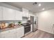 A modern kitchen equipped with stainless steel appliances, white cabinetry, and sleek countertops at 7910 Pandora Sky St # 271, North Las Vegas, NV 89084