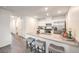 An open-concept kitchen featuring a breakfast bar, stainless steel appliances, and modern fixtures at 7910 Pandora Sky St # 271, North Las Vegas, NV 89084