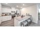 Well-lit kitchen boasts white cabinetry, a breakfast bar, stainless steel appliances, and stylish fixtures at 7910 Pandora Sky St # 271, North Las Vegas, NV 89084
