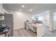 Open-concept kitchen area with stainless steel appliances, a breakfast bar, and wood-look flooring at 7910 Pandora Sky St # 271, North Las Vegas, NV 89084