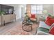 Inviting living room with modern decor, wood floors, and large windows for natural light at 7910 Pandora Sky St # 271, North Las Vegas, NV 89084