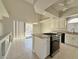 Bright kitchen with tile flooring, white cabinets, and a door leading to the outside at 8717 Harvest Valley Ave, Las Vegas, NV 89129