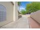 Private and spacious side yard with a covered patio, desert landscaping, and a stucco wall at 880 Autumn Canyon Way, Henderson, NV 89002