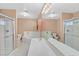 Large bathroom featuring dual sinks, a soaking tub, and a glass-enclosed shower, with ample lighting at 880 Autumn Canyon Way, Henderson, NV 89002