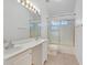 Bathroom featuring double sinks, large mirror, shower, and bathtub at 880 Autumn Canyon Way, Henderson, NV 89002