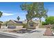 Inviting one-story home with a two-car garage, desert landscaping, solar panels, and mature shade trees at 880 Autumn Canyon Way, Henderson, NV 89002