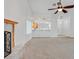 Open living space with fireplace, modern ceiling fan, shuttered windows, and an eat-in kitchen at 880 Autumn Canyon Way, Henderson, NV 89002