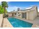 Private backyard pool with a tiled patio area, perfect for entertaining and relaxation, and solar panels at 880 Autumn Canyon Way, Henderson, NV 89002