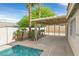 Enjoy the covered patio overlooking the sparkling pool, surrounded by lush palm trees and desert landscaping at 880 Autumn Canyon Way, Henderson, NV 89002