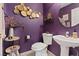 Stylish powder room with purple walls, decorative accents, and modern fixtures at 9153 Beauchamp Ave, Las Vegas, NV 89148