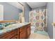 Bathroom featuring a wood vanity with a bright countertop and decorative shower curtain at 9153 Beauchamp Ave, Las Vegas, NV 89148