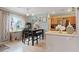 Cozy dining area featuring natural light, modern decor, and access to the kitchen with stainless steel appliances at 9153 Beauchamp Ave, Las Vegas, NV 89148